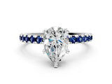 White gold Pear Cut Diamond Solitaire Ring with Round with Blue Sapphire side stone Pavé Band and Four-Prong Setting