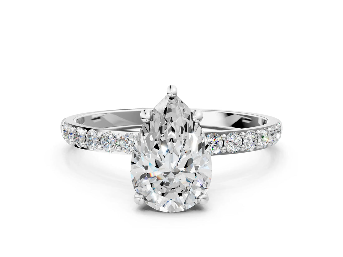 White gold Pear Cut Diamond Solitaire Ring with Round with Moissanite side stone Pavé Band and Prong Setting