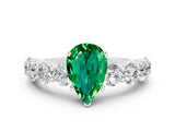 White gold Pear Cut Emerald Prong Setting with Side Stones on a Pave Band