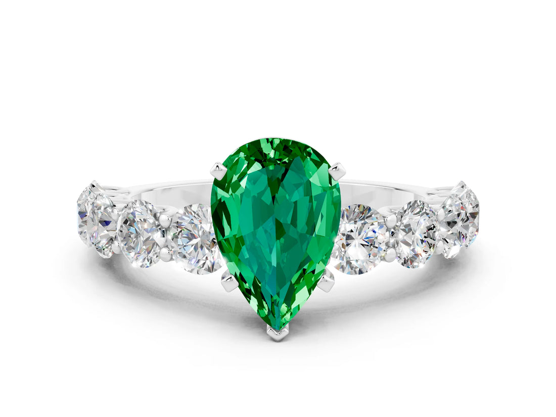 White gold Pear Cut Emerald Prong Setting with Side Stones on a Pave Band