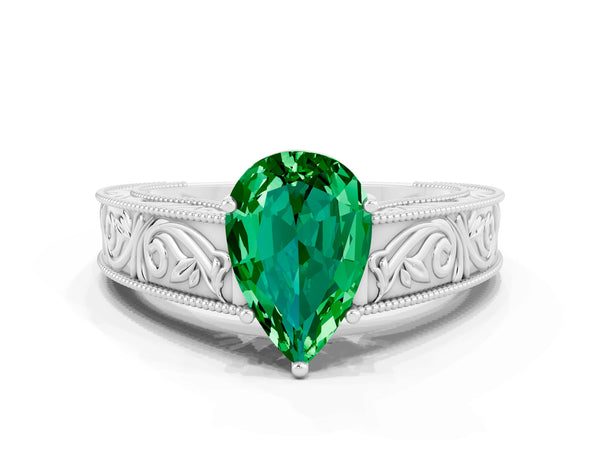 White gold Pear Cut Emerald Solitaire Ring with Engraved Band and Four-Prong Setting