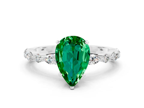 White gold Pear Cut Emerald Solitaire with Side Stones on a Pavé Band and Four-Prong Setting