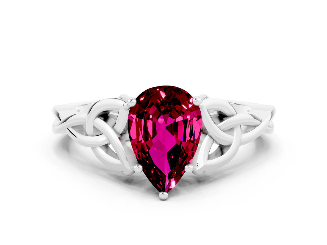 White gold Pear Cut Garnet Solitaire Engagement Ring with Celtic Knot Band and Four-Prong Setting