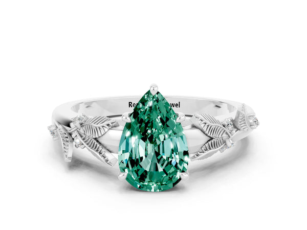 Platinum Pear Cut Green Sapphire Solitaire Ring with Leaf Motif Band and Four-Prong Setting