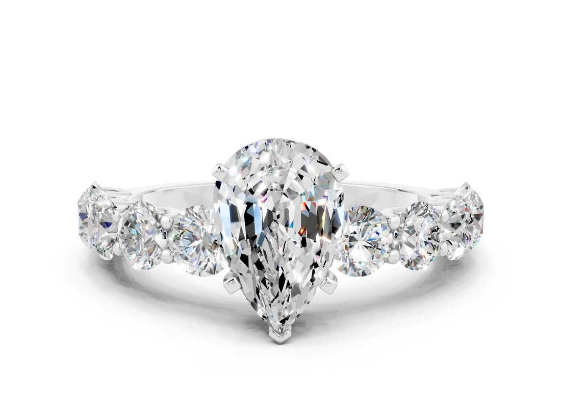 White gold Pear Cut Moissanite Prong Setting with Side Stones on a Pave Band