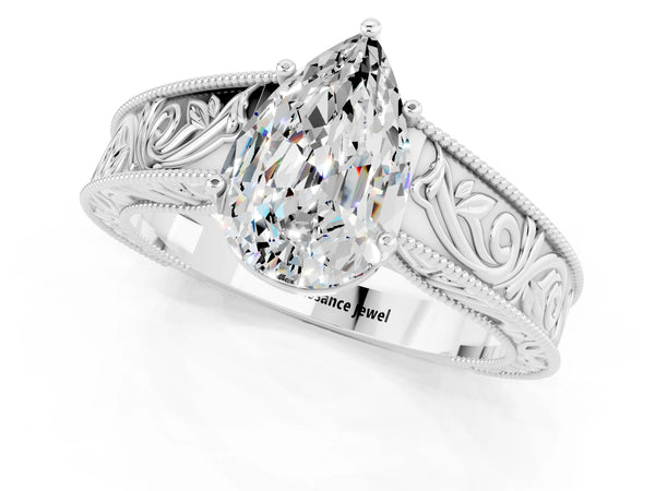 White gold Pear Cut Moissanite Solitaire Ring with Engraved Band and Four-Prong Setting