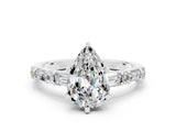 White gold Pear Cut Moissanite Solitaire with Side Baguettes and Channel Set Band