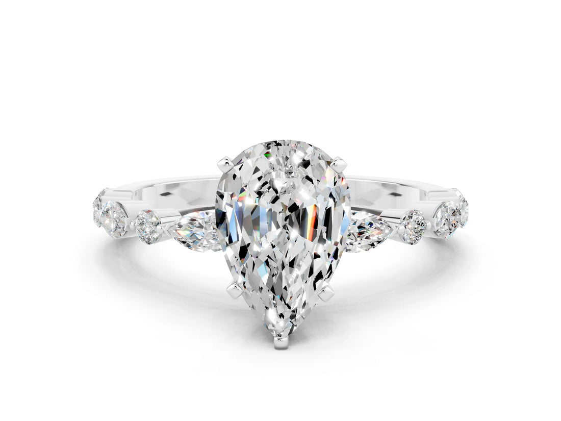 White gold Pear Cut Moissanite Solitaire with Side Stones on a Pavé Band and Four-Prong Setting