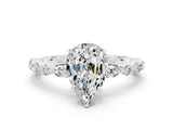 White gold Pear Cut Moissanite Solitaire with Side Stones on a Pavé Band and Four-Prong Setting
