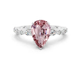 White gold Pear Cut Morganite Solitaire with Side Stones on a Pavé Band and Four-Prong Setting