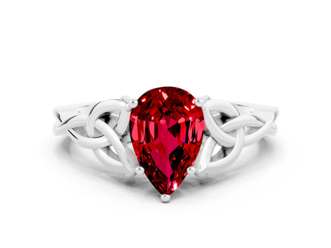 White gold Pear Cut Ruby Solitaire Engagement Ring with Celtic Knot Band and Four-Prong Setting