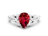 White gold Pear Cut Ruby Solitaire Engagement Ring with Celtic Knot Band and Four-Prong Setting