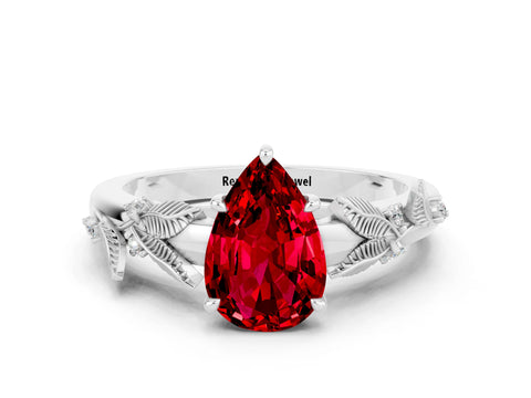 White gold Pear Cut Ruby Solitaire Ring with Leaf Motif Band and Four-Prong Setting