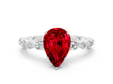 White gold Pear Cut Ruby Solitaire with Side Stones on a Pavé Band and Four-Prong Setting
