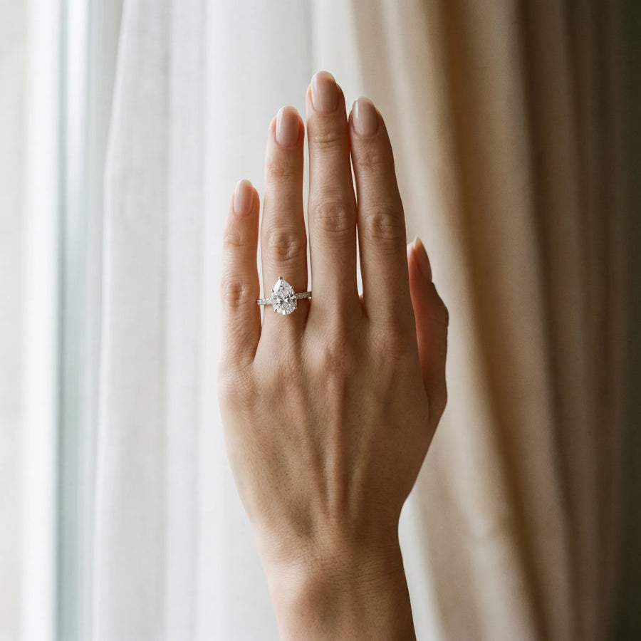 White gold Pear Cut Solitaire Diamond Ring with Pave Band and Four-Prong Setting