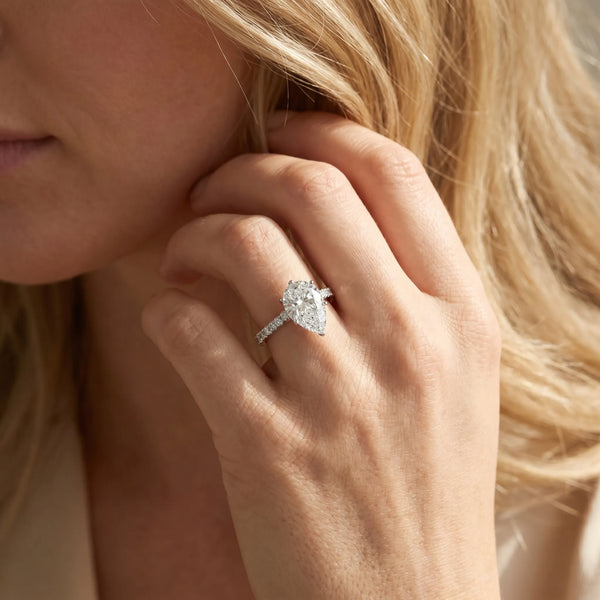 White gold Pear Cut Solitaire Diamond Ring with Pave Band and Four-Prong Setting