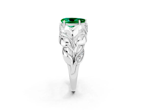 Platinum Pear Cut Emerald Leaf-Inspired Engagement Ring with Round Accents and Prong Setting