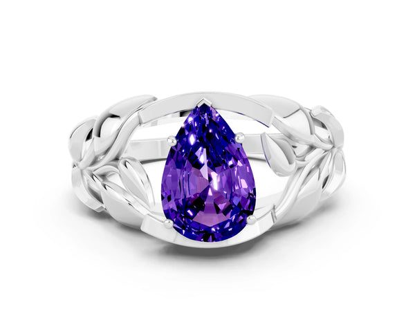 Platinum Pear Cut Tanzanite Leaf-Inspired Engagement Ring with Round Accents and Prong Setting
