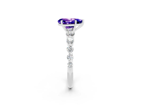 Platinum Pear Cut Solitaire Tanzanite Ring with Pave Band and Four-Prong Setting