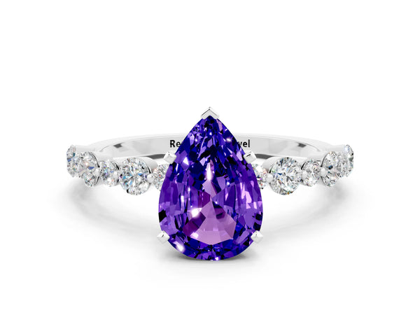 Platinum Pear Cut Tanzanite Prong Set Engagement Ring with Pavé Band