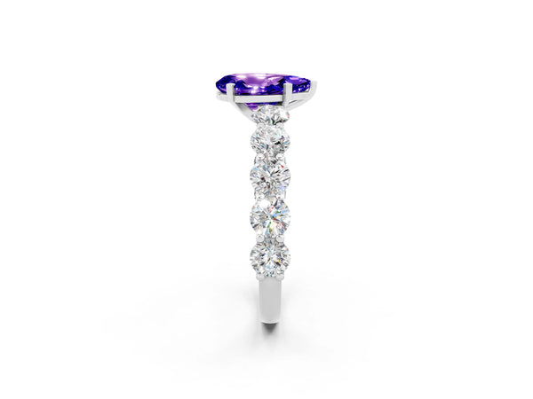 Platinum Pear Cut Tanzanite Prong Setting with Side Stones on a Pave Band