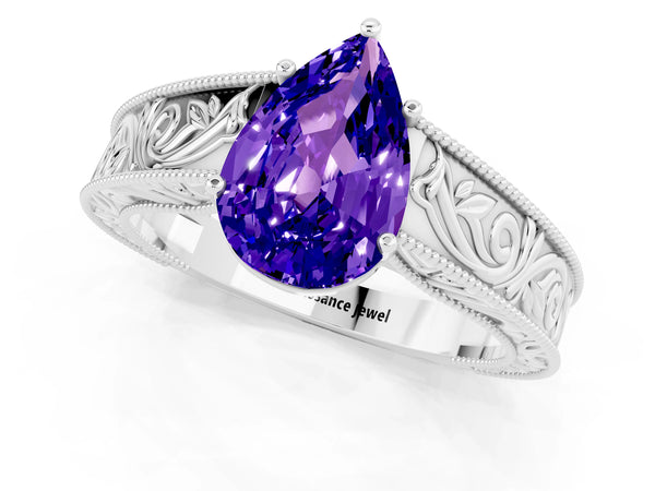 Silver Pear Cut Tanzanite Solitaire Ring with Engraved Band and Four-Prong Setting