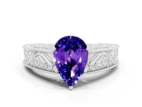 White gold Pear Cut Tanzanite Solitaire Ring with Engraved Band and Four-Prong Setting