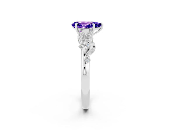 Platinum Pear Cut Tanzanite Solitaire Ring with Leaf Motif Band and Four-Prong Setting