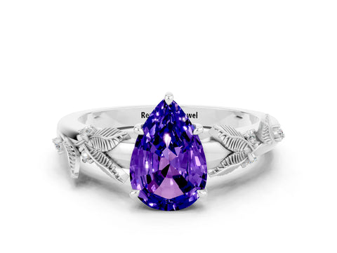 White gold Pear Cut Tanzanite Solitaire Ring with Leaf Motif Band and Four-Prong Setting