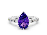 White gold Pear Cut Tanzanite Solitaire with Side Baguettes and Channel Set Band