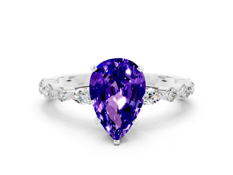 White gold Pear Cut Tanzanite Solitaire with Side Stones on a Pavé Band and Four-Prong Setting