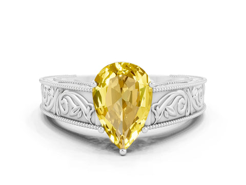 White gold Pear Cut Yellow Sapphire Solitaire Ring with Engraved Band and Four-Prong Setting
