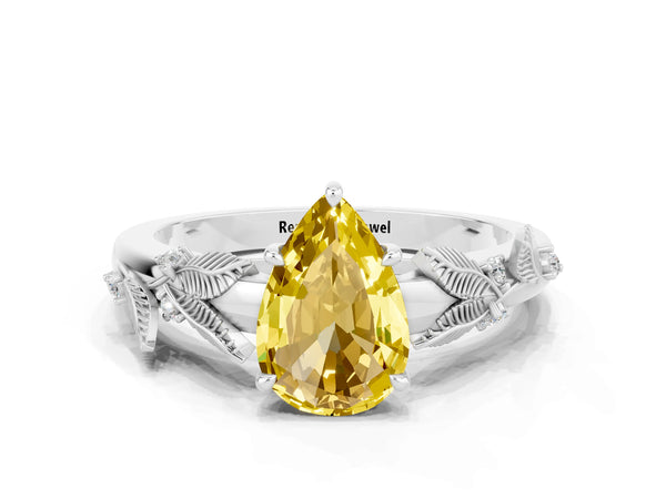 Platinum Pear Cut Yellow Sapphire Solitaire Ring with Leaf Motif Band and Four-Prong Setting