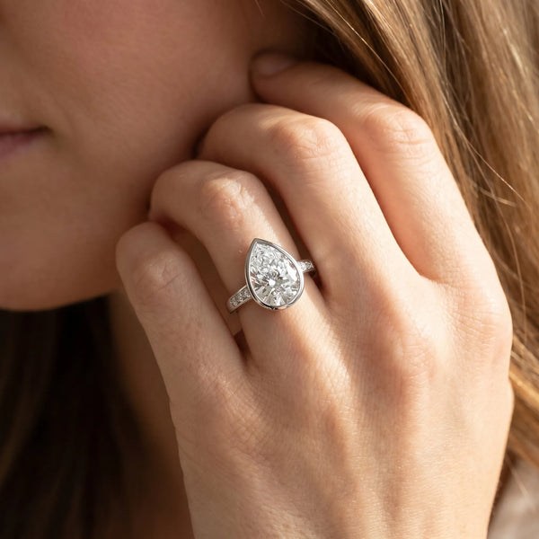 White gold Pear Diamond Solitaire Ring with Bezel Setting and Classic Band