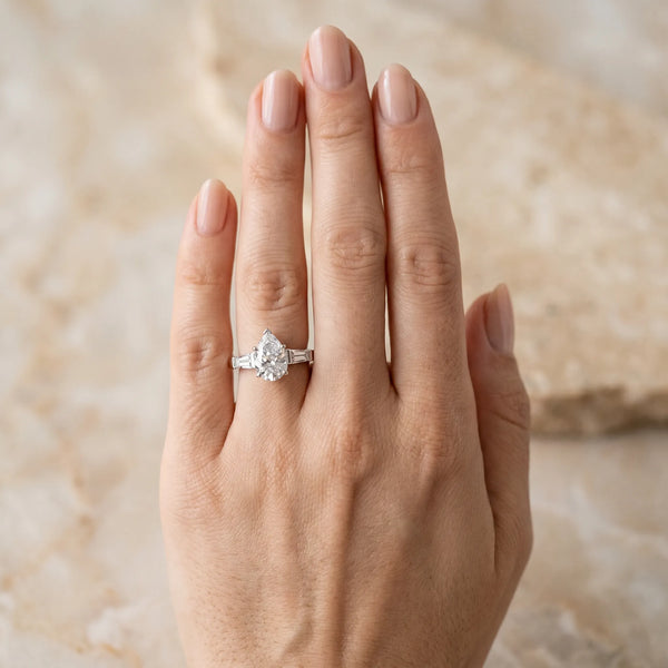 White gold Pear Solitaire with Tapered Baguette Side Stones on a Classic Band with Six-Prong Setting