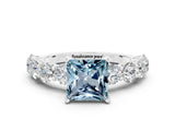 White gold Princess Cut Aquamarine Prong Setting with Side Stones on a Pave Band