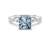 White gold Princess Cut Aquamarine Solitaire with Side Stones on a Pavé Band and Four-Prong Setting