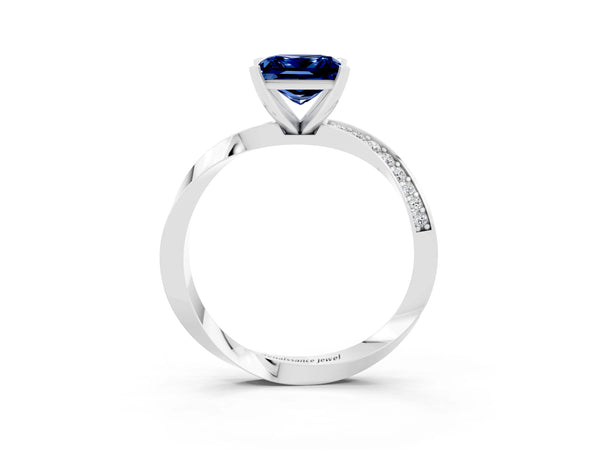 Platinum Princess Cut Blue Sapphire Engagement Ring with Side Stone Accents and Four-Prong Setting