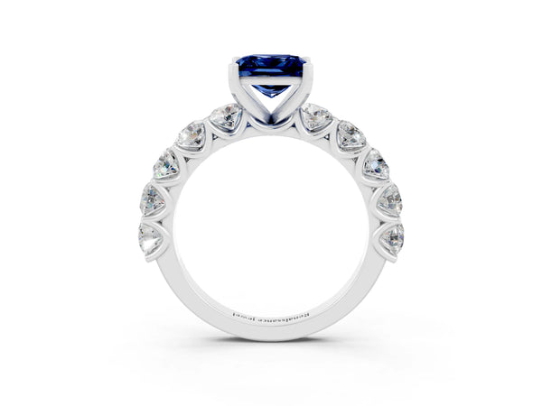 White gold Princess Cut Blue Sapphire Prong Setting with Side Stones on a Pave Band