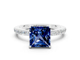 White gold Princess Cut Blue Sapphire Solitaire Engagement Ring with Pavé Band and Four-Prong Setting