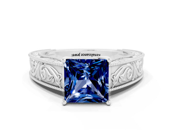 White gold Princess Cut Blue Sapphire Solitaire Ring with Engraved Band and Four-Prong Setting