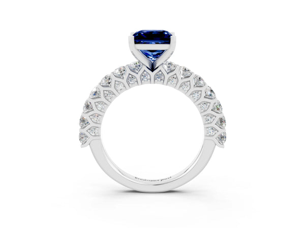 Platinum Princess Cut Blue Sapphire Solitaire Ring with Shared Prong Pavé Band and Four-Prong Setting