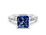White gold Princess Cut Blue Sapphire Solitaire with Side Baguettes and Channel Set Band