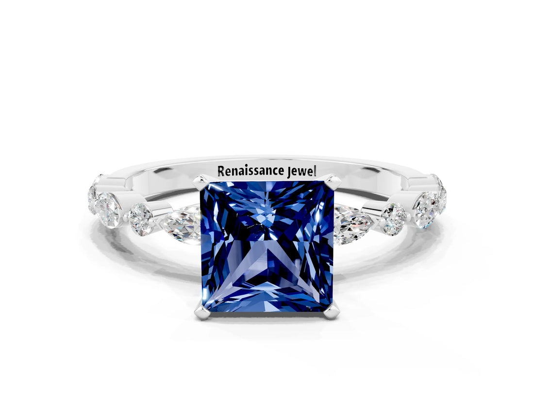 White gold Princess Cut Blue Sapphire Solitaire with Side Stones on a Pavé Band and Four-Prong Setting