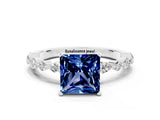White gold Princess Cut Blue Sapphire Solitaire with Side Stones on a Pavé Band and Four-Prong Setting