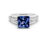White gold Princess Cut Blue Sapphire Split Shank Engagement Ring with Pavé Band