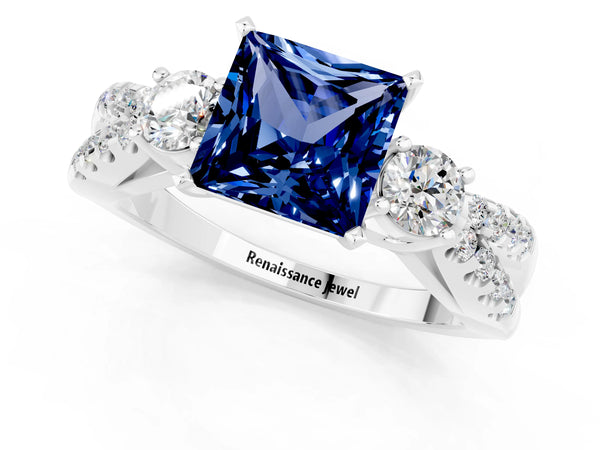 Platinum Princess Cut Blue Sapphire Three-Stone Ring with Pavé Split Shank and Four-Prong Setting