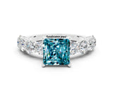 White gold Princess Cut Blue Topaz Prong Setting with Side Stones on a Pave Band