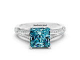 White gold Princess Cut Blue Topaz Split Shank Engagement Ring with Pavé Band