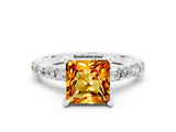 White gold Princess Cut Citrine Solitaire with Side Baguettes and Channel Set Band